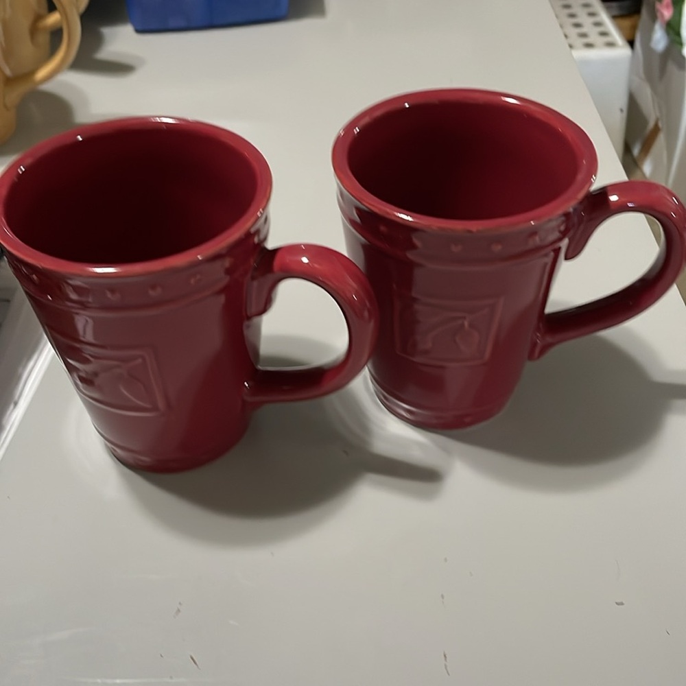 Two dark red Sorrento (Debby Segura Designs) ceramic coffee mugs